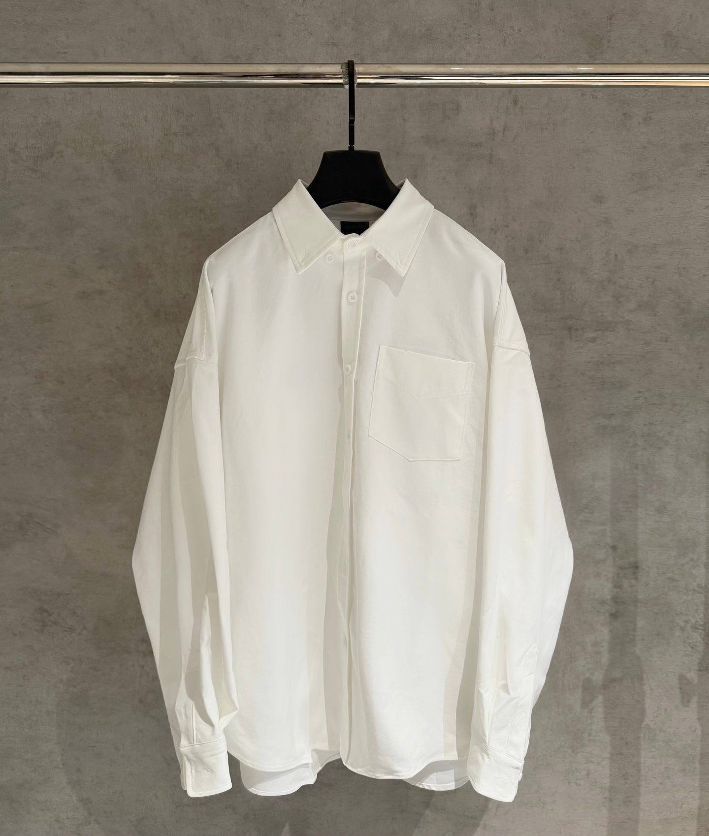 White button-up shirt with pointed collar and chest pocket, long sleeves