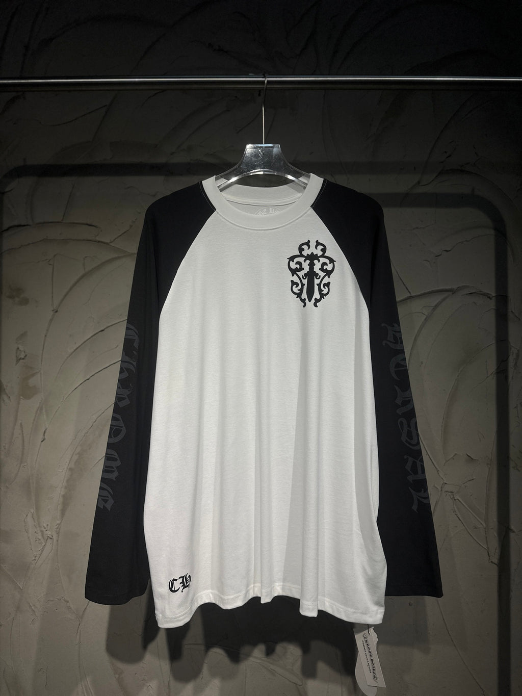 White raglan long-sleeve shirt, black sleeves, crest graphic front
