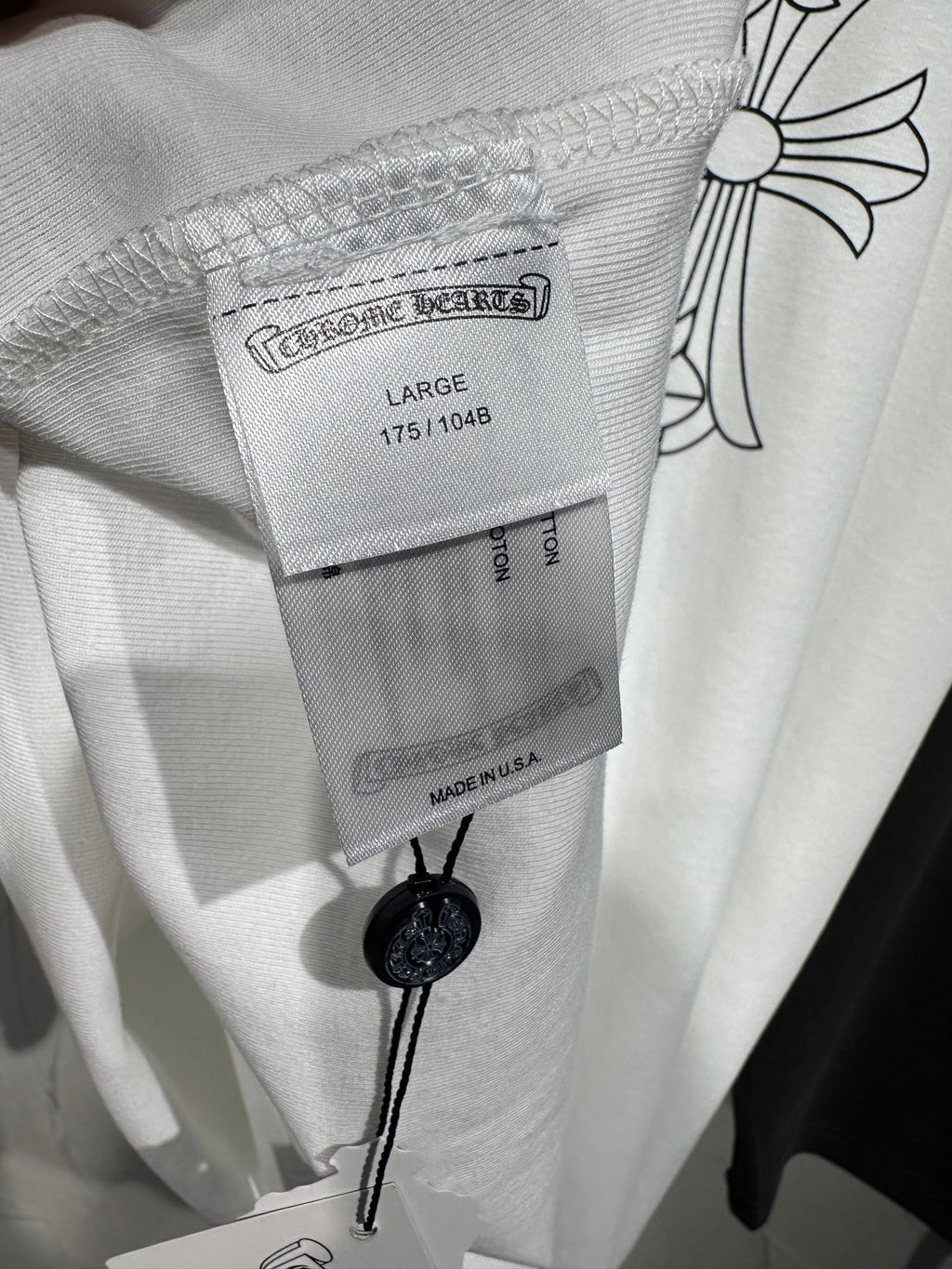 Long-sleeve shirt collar with size and brand tag on heather gray knit