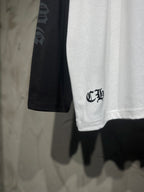 White hem with small black emblem and black raglan sleeve detail