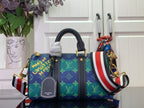 Blue monogram handbag with dark leather trim, top handles, and red-white-blue stripe strap