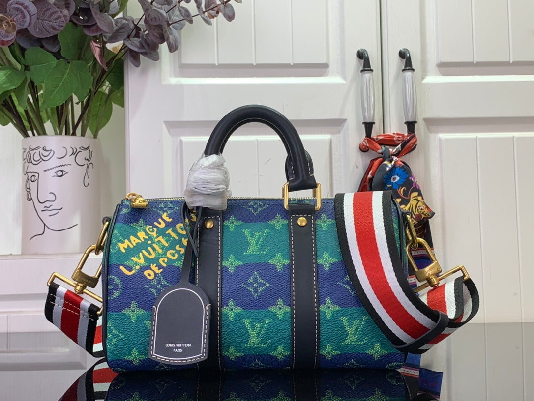 Blue monogram handbag with dark leather trim, top handles, and red-white-blue stripe strap