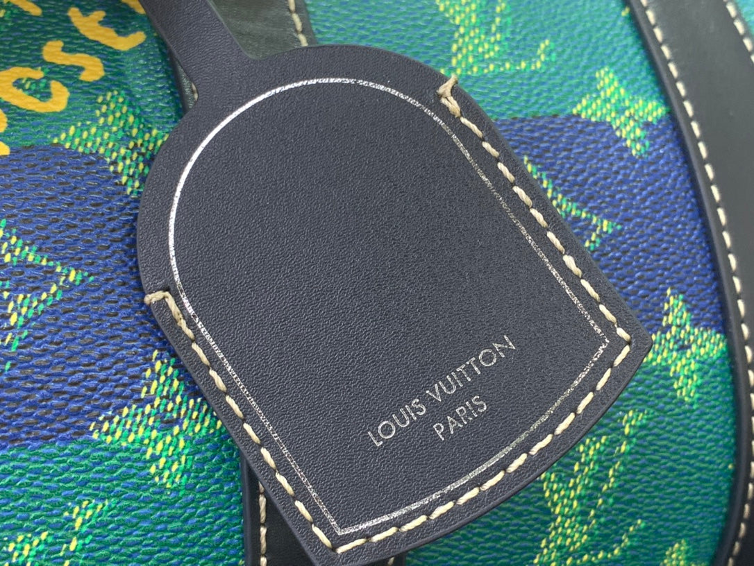 Louis Vuitton embossed black leather patch on blue patterned bag