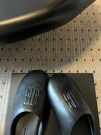 Balenciaga logo slide sandals, dark leather with embossed logo on uppers