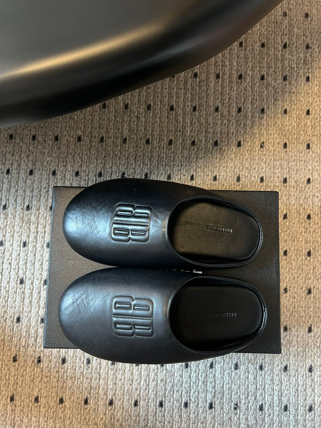 Balenciaga logo slide sandals, side view with footbed openings and logos
