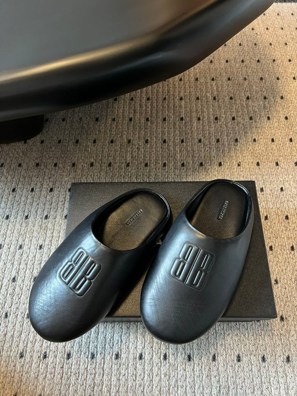 Balenciaga logo slide sandals, dark leather pair on a box