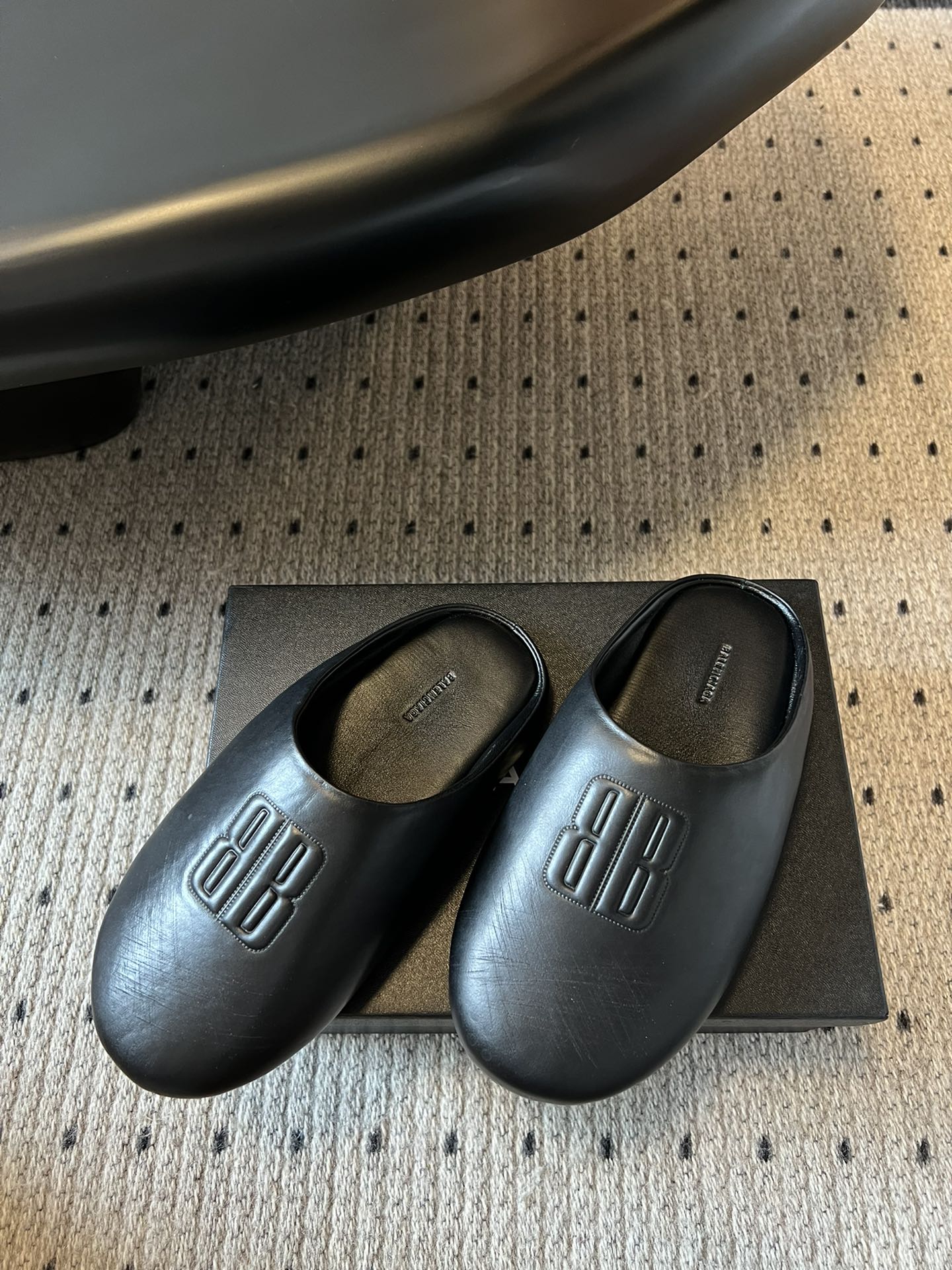 Balenciaga logo slide sandals, dark leather pair on a box
