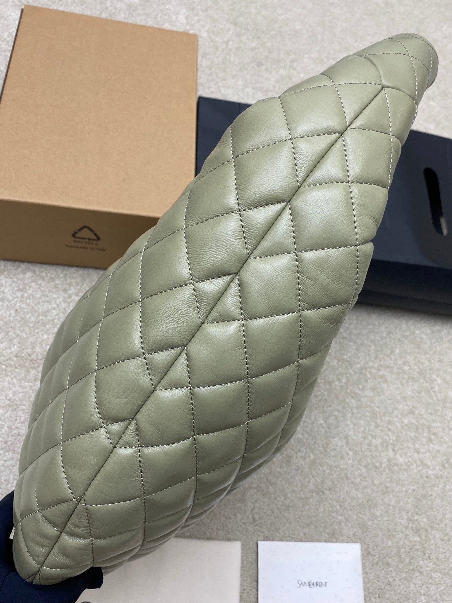Sage green quilted hobo bag, side view with padded handle