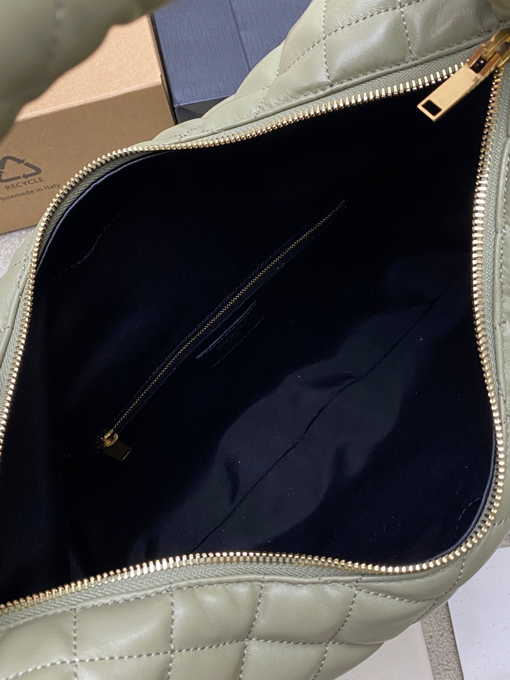 Sage green hobo bag interior view with navy lining and zip compartment