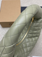 Sage green quilted hobo bag with front zip opening detail
