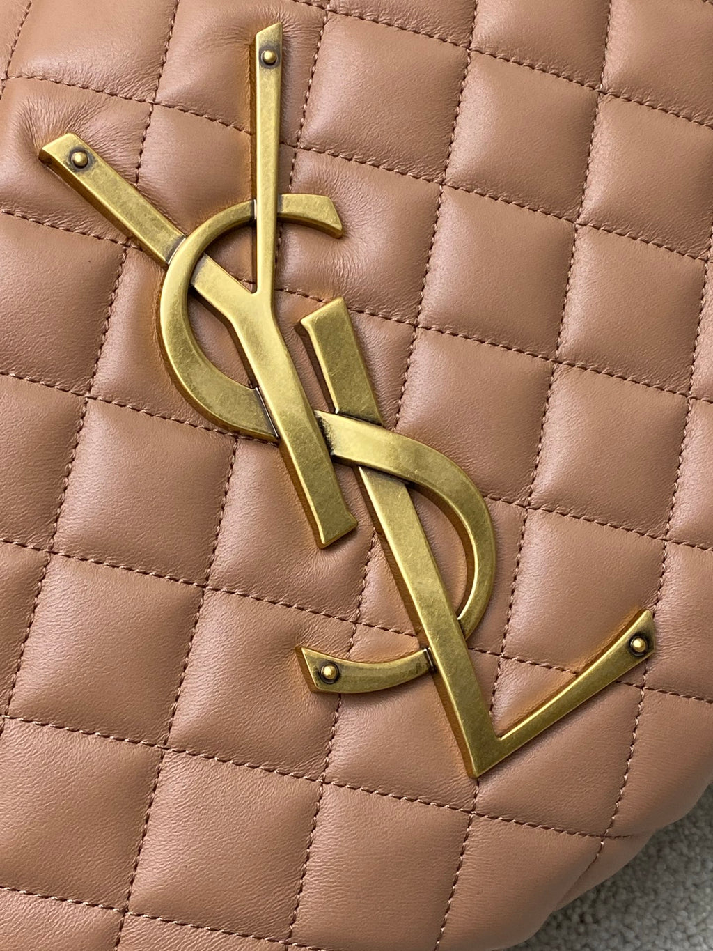 Gold YSL monogram hardware on tan quilted leather, stitched diamond pattern