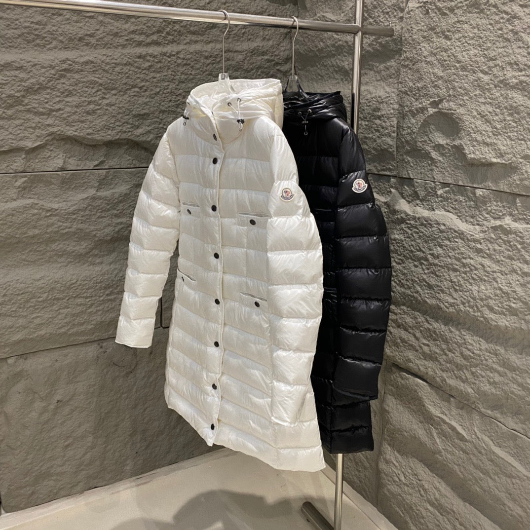 Hooded long puffer coats in white and black, button front on hangers