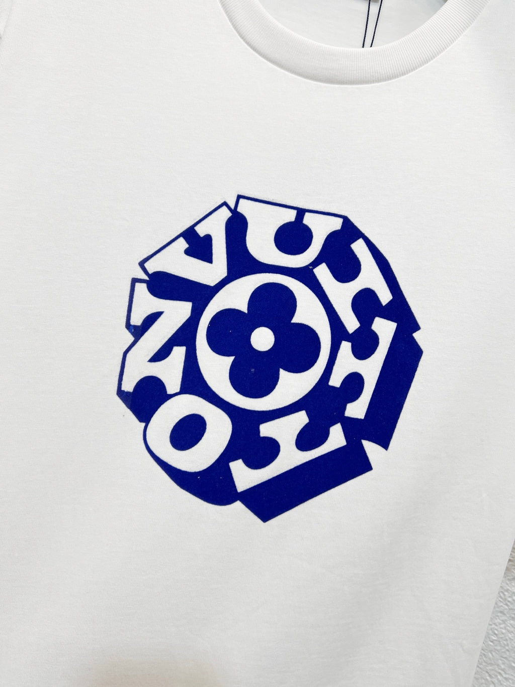 White T-shirt chest with blue abstract logo emblem