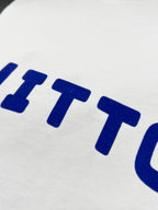 White T-shirt fabric with blue 'VUITTON' lettering detail