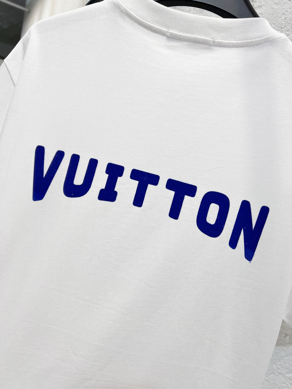 White T-shirt with blue 'VUITTON' lettering