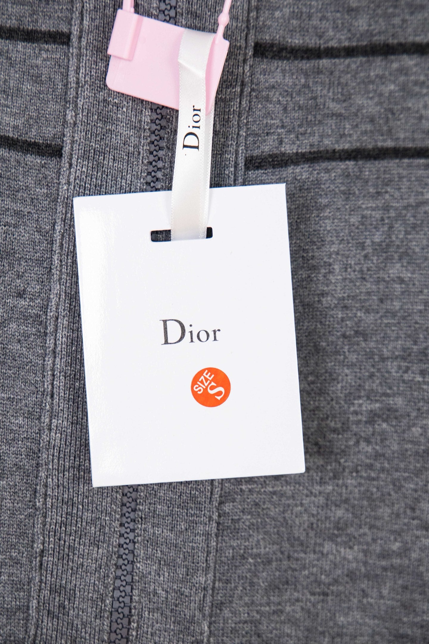 Gray Dior hoodie knit with front seam detail and hanging white retail tag