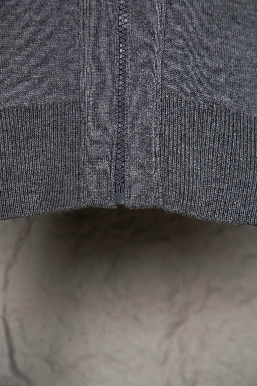Gray Dior hoodie hem with central zipper seam and ribbed knit edge