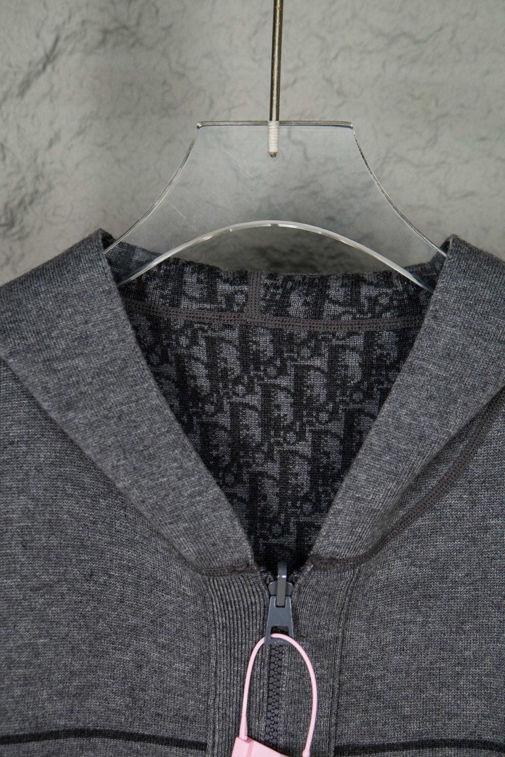 Gray Dior zip hoodie close-up of hood opening and front zipper pull