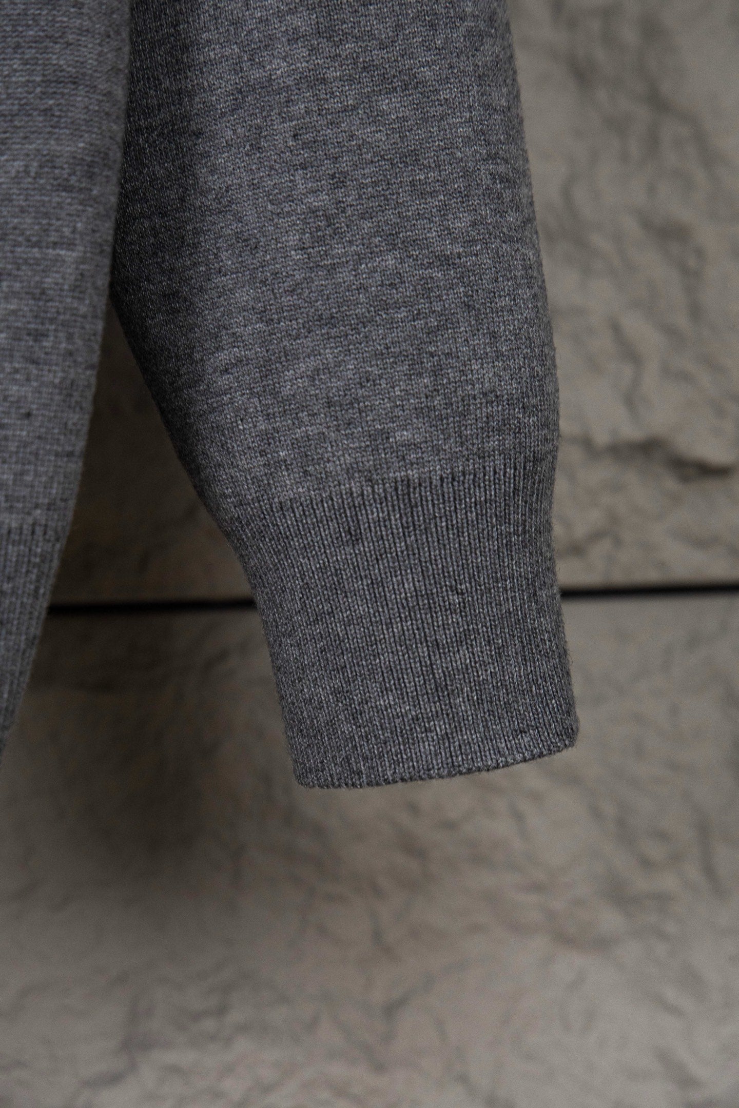 Gray Dior hoodie lower sleeve with ribbed cuff and knit fabric texture