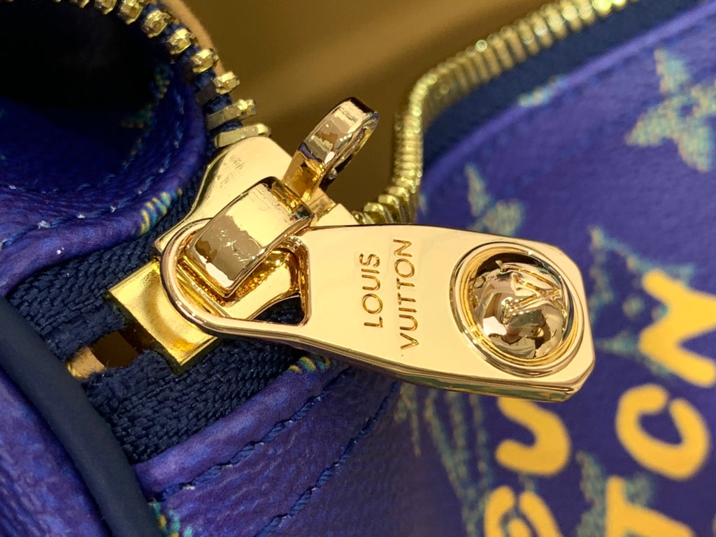 Gold-tone Louis Vuitton clasp and zipper pull on blue monogram bag interior