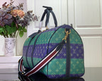 Multicolor duffel bag with striped shoulder strap and gold-tone hardware
