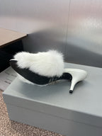 White faux-fur slide mule with slim stiletto heel, side profile.