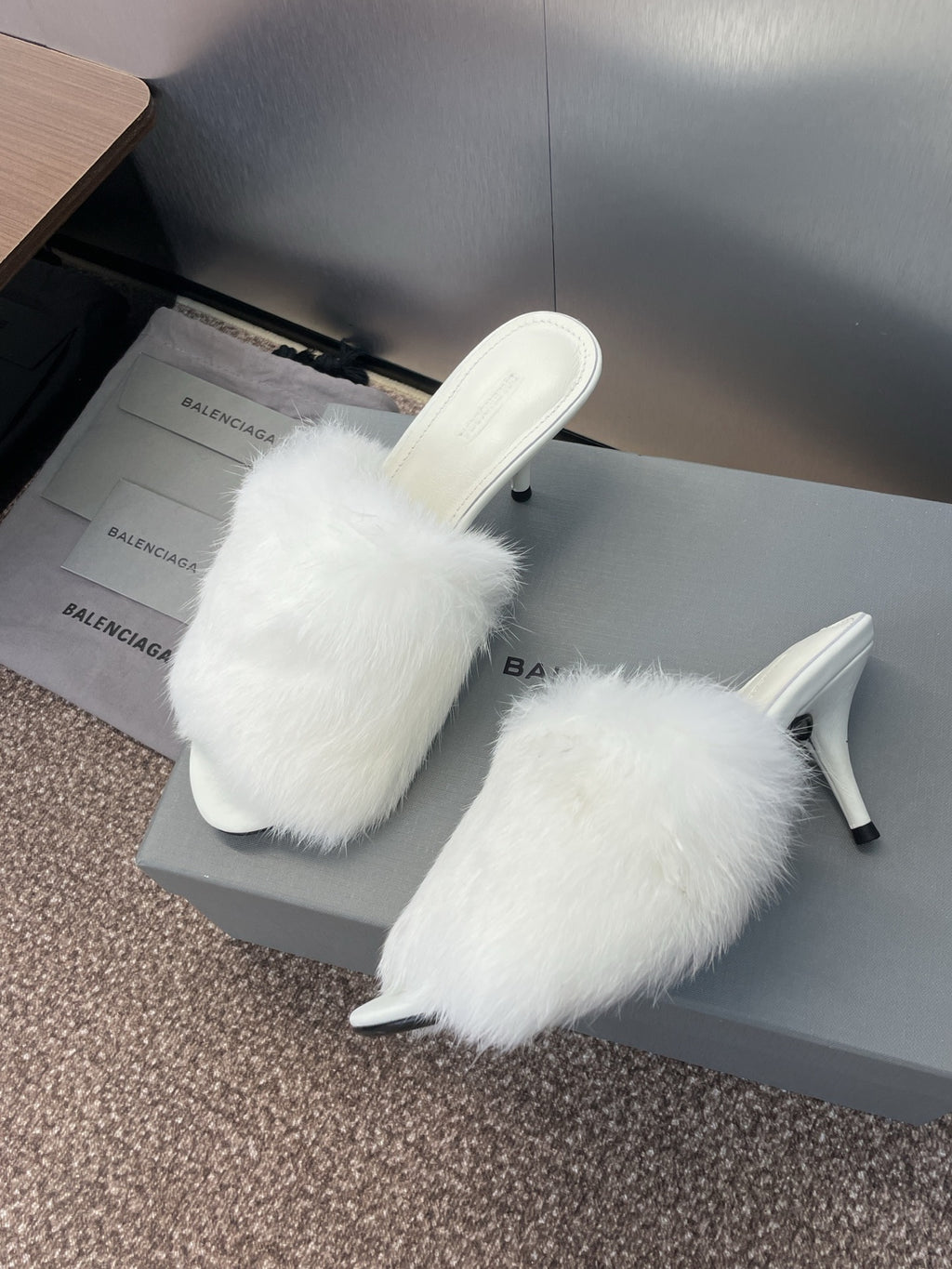 White faux-fur slip-on sandals with slim stiletto heel, open toe.