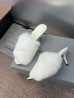 White faux-fur slip-on sandals with slim stiletto heel, open toe.