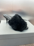 Black faux-fur slide sandal with open toe and slender heel.