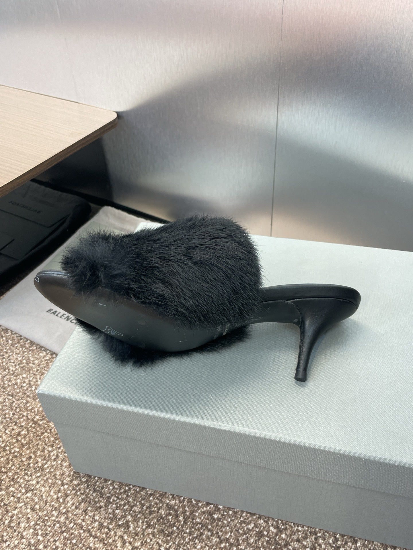Black faux-fur slide sandal with open toe and tall stiletto heel.