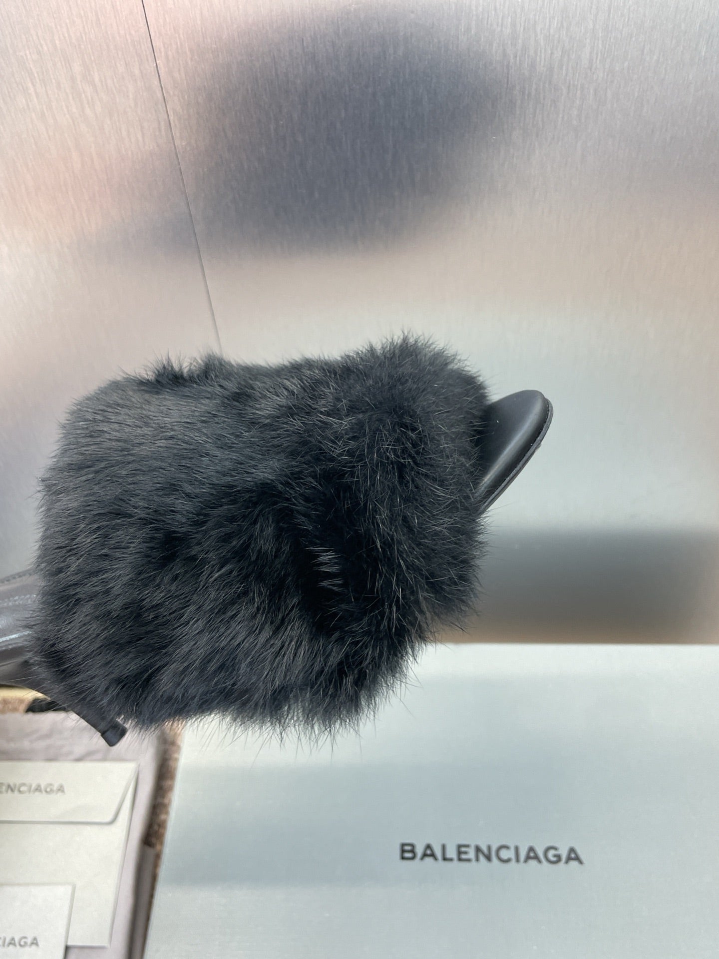 Black faux-fur slide sandal detail on open toe and stiletto heel.