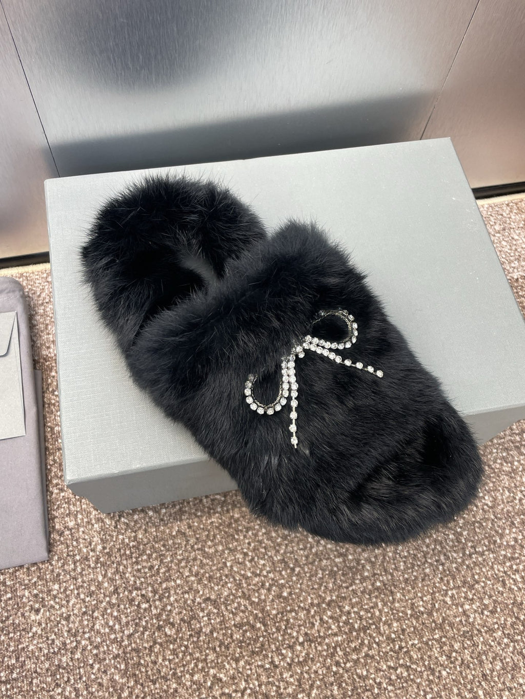 Balenciaga black fur slide sandals with crystal bow and small bead accents