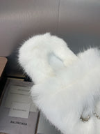 White fuzzy slide sandal top with rhinestone bow detail, angled close-up