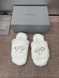 White fluffy slide sandals with rhinestone bow detail on top