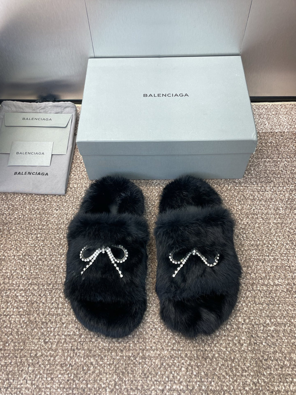 Balenciaga black fur slide sandals with rhinestone bow detail