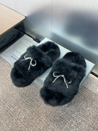 Balenciaga black fur slide sandals with crystal bow and dangling chain