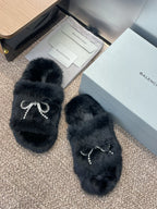 Balenciaga black fur slide sandals with rhinestone bow on the strap