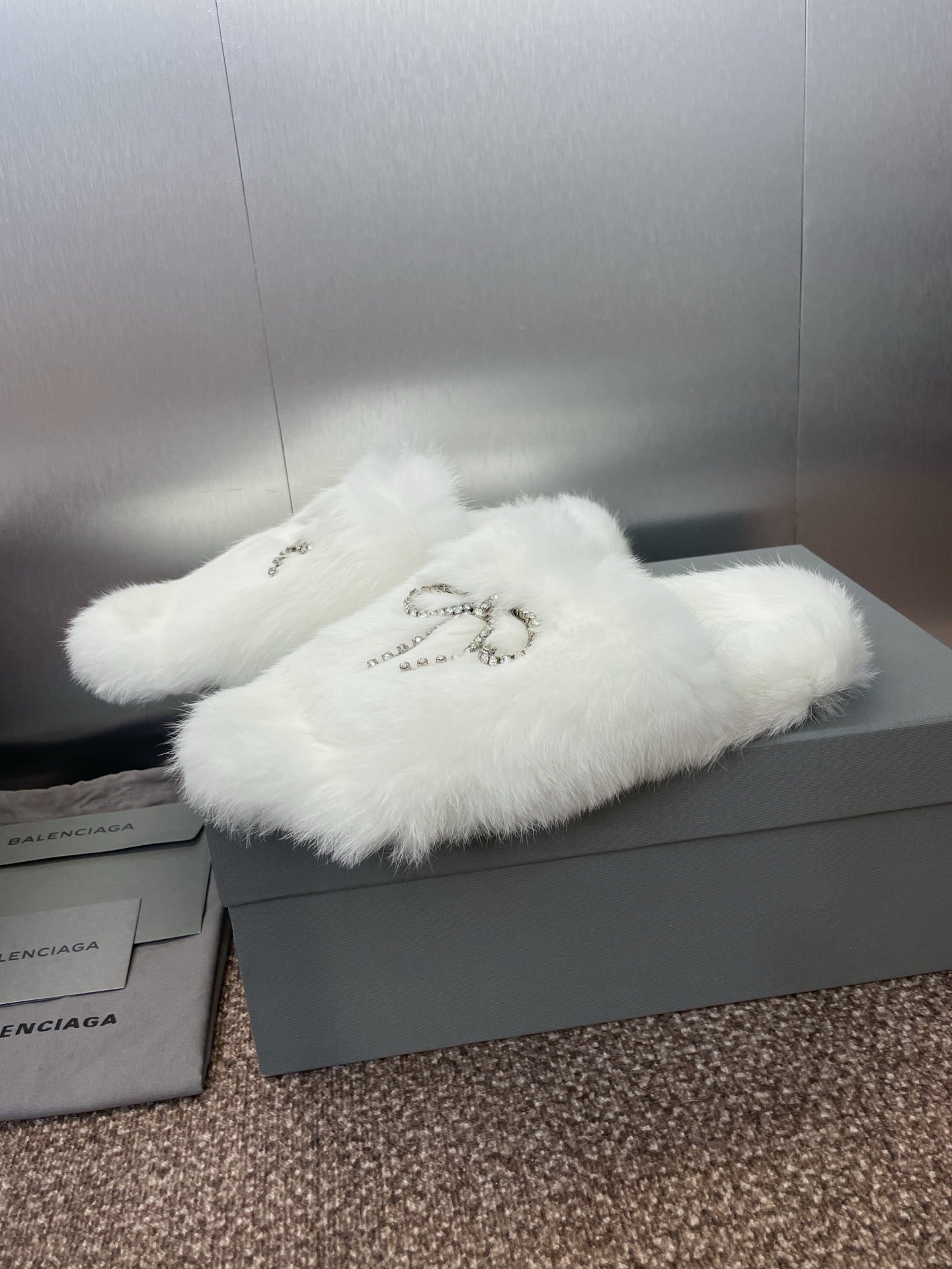 White fluffy slide sandals with rhinestone bow detail on top