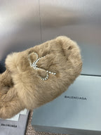 Tan fur slide sandal with rhinestone bow accent on the upper
