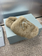 Tan fur slide sandals with rhinestone bow charm on the front strap