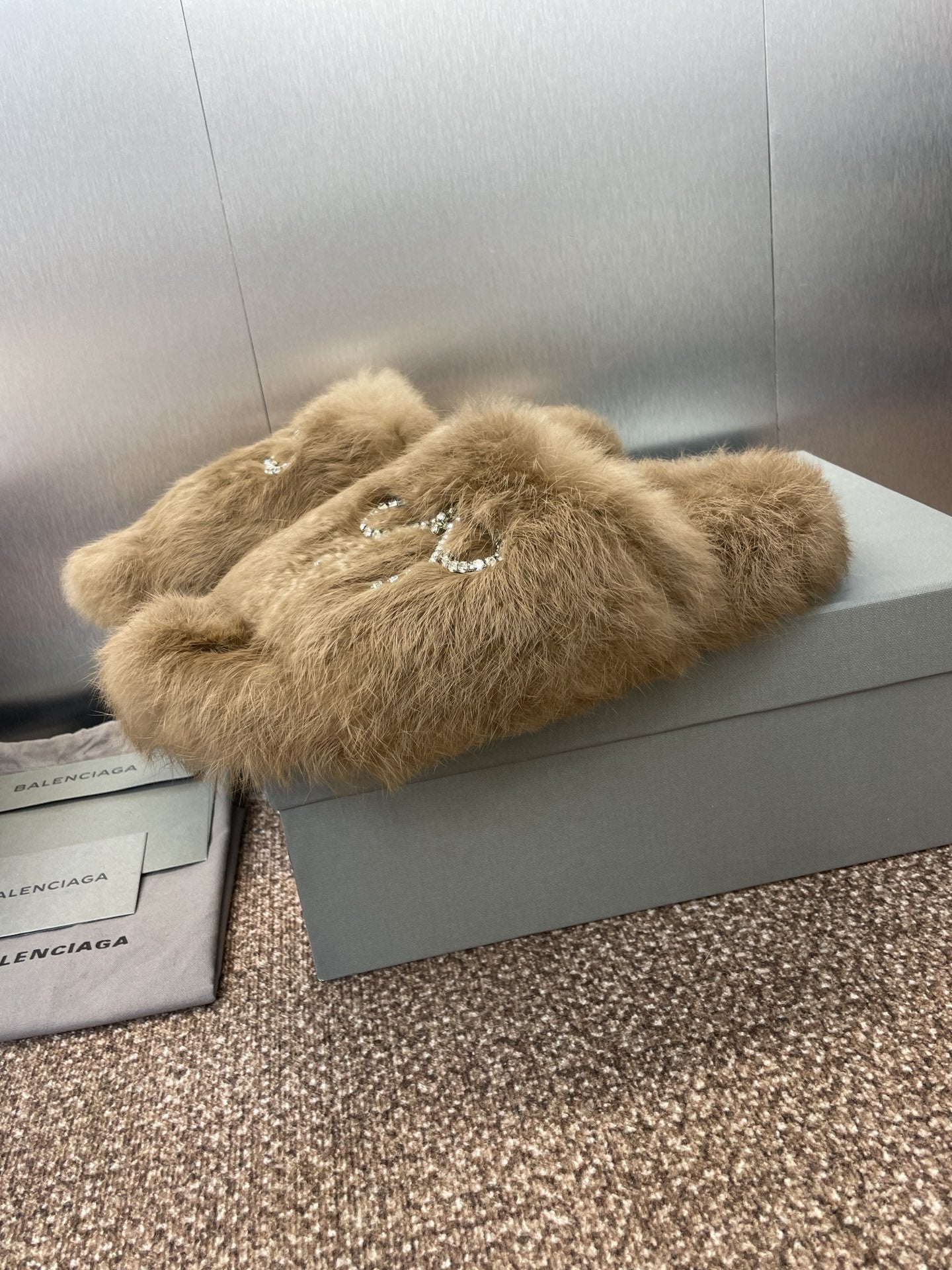 Tan fuzzy slide sandal with rhinestone bow charm on the top