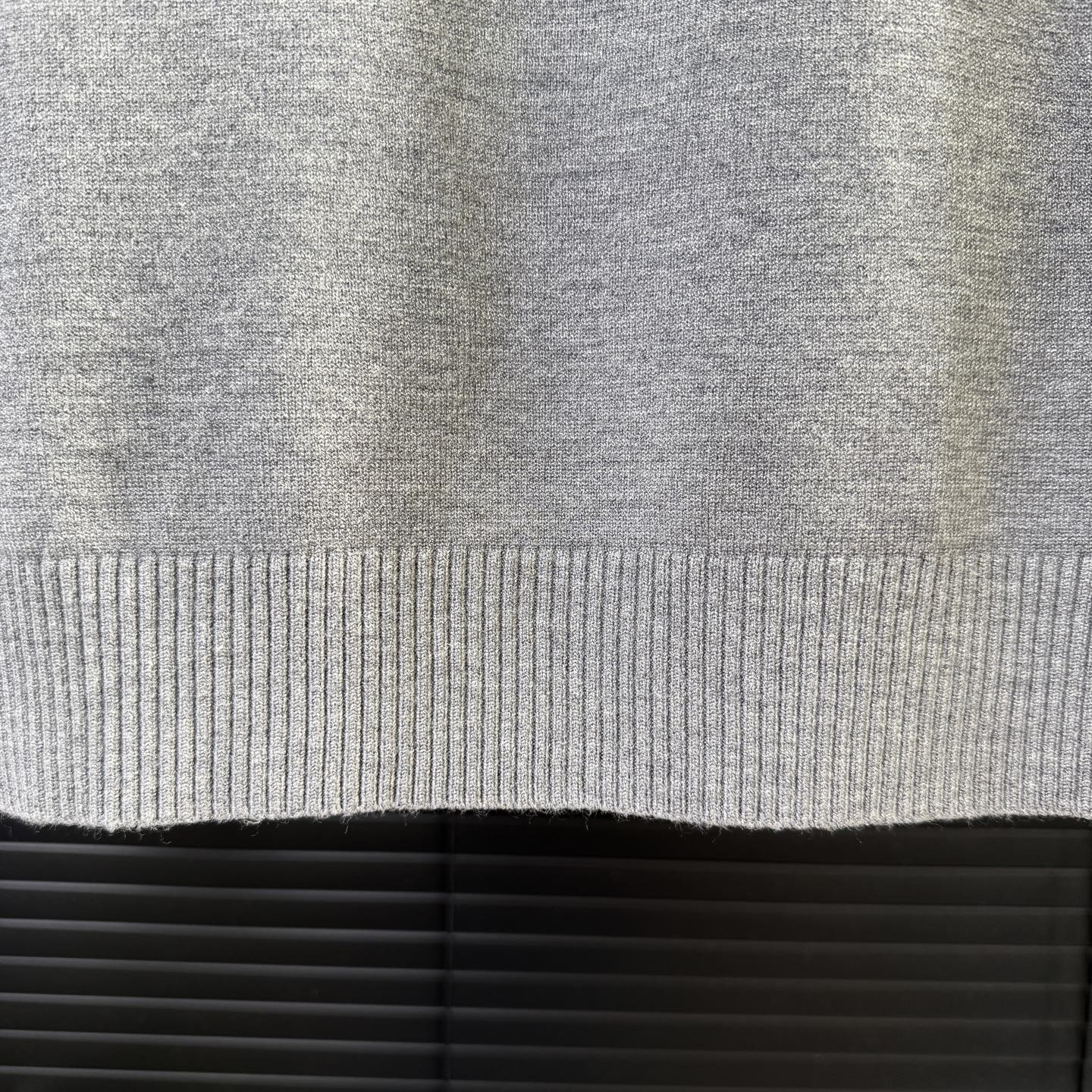 Gray ribbed knit sweater hem edge