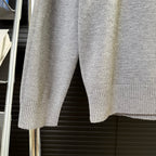 Gray knit sweater sleeves and ribbed hem