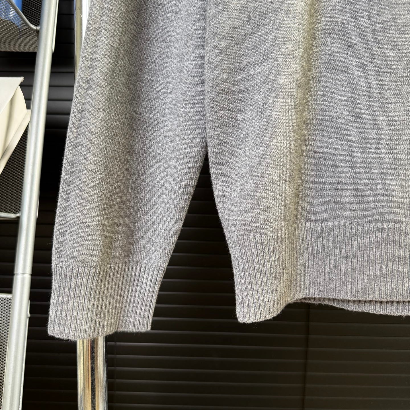 Gray knit sweater sleeves and ribbed hem