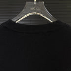 Black Moncler sweater collar area with ribbed crew neck detail