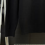 Black Moncler sweater sleeves and ribbed hem cuff detail
