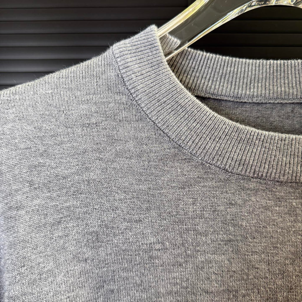 Gray knit sweater shoulder with ribbed collar