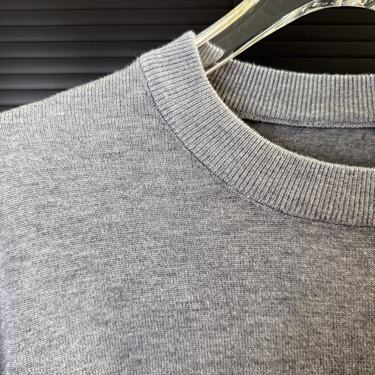 Gray knit sweater shoulder with ribbed collar