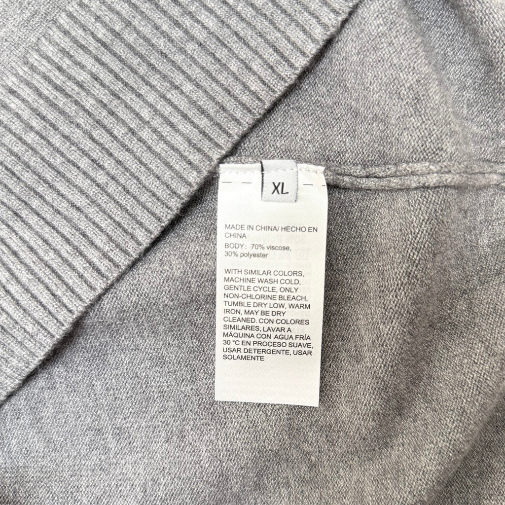 Size XL care label on gray knit sweater