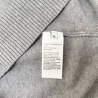 Size XL care label on gray knit sweater